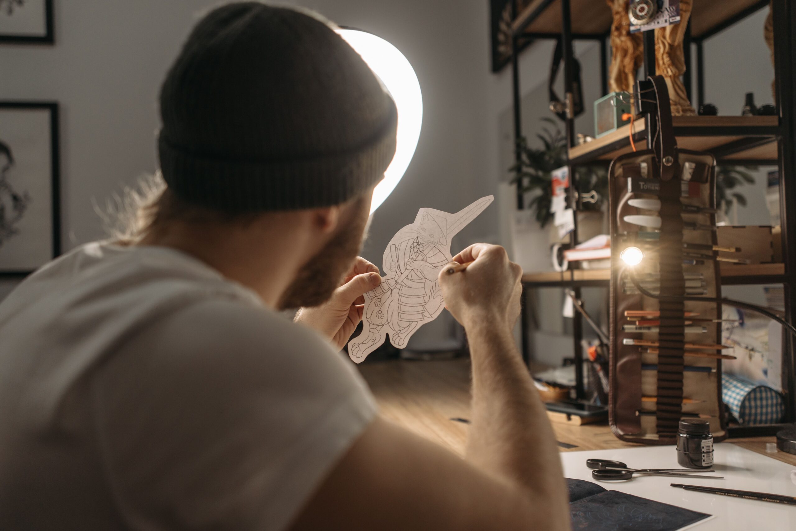 Tattoo artist reviewing a hand-drawn tattoo design in a studio
